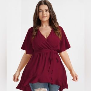 Bloomchic Solid Belted Asymmetrical Hem Flutter Wrap Blouse in Burgundy